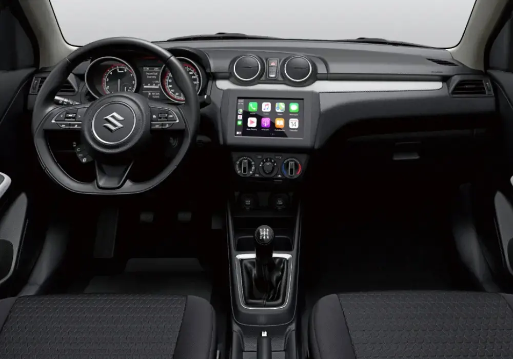 Interior del Suzuki Swift: Volante, pantalla táctil y consola central.