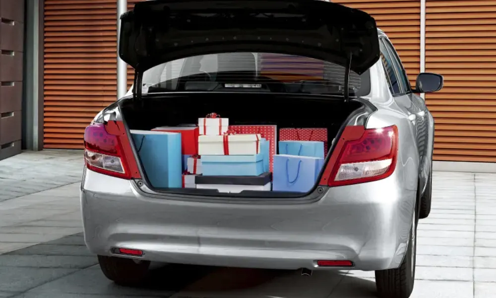 Sedán Suzuki Dzire con el maletero lleno de regalos.